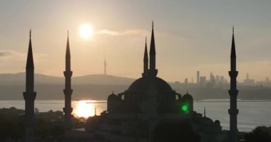 Istanbul, Turkey. Sultanahmet with the Blue Mosque and the Hagia Sophia with a Golden Horn on the background at sunrise. Cinematic Aerial view. Hi quality 4K footage.