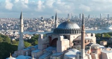 Istanbul, Turkey. Sultanahmet with the Blue Mosque and the Hagia Sophia with a Golden Horn on the background at sunrise. Cinematic Aerial view. Hi quality 4K footage.