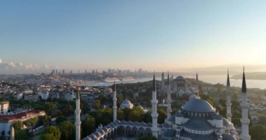 Istanbul, Turkey. Sultanahmet with the Blue Mosque and the Hagia Sophia with a Golden Horn on the background at sunrise. Cinematic Aerial view. Hi quality 4K footage.