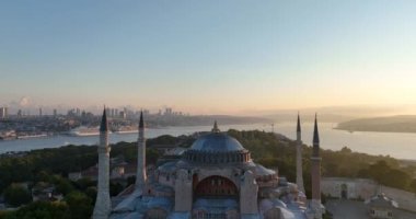 Istanbul, Turkey. Sultanahmet area with the Blue Mosque and the Hagia Sophia with a Golden Horn and Bosphorus bridge in the background at sunrise. Cinematic Aerial view. Hi quality 4K footage.