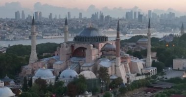 Istanbul, Turkey. Sultanahmet with the Blue Mosque and the Hagia Sophia with a Golden Horn on the background at sunrise. Cinematic Aerial view. Hi quality 4K footage.