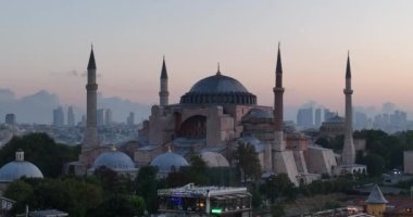 Istanbul, Turkey. Sultanahmet with the Blue Mosque and the Hagia Sophia with a Golden Horn on the background at sunrise. Cinematic Aerial view. Hi quality 4K footage.