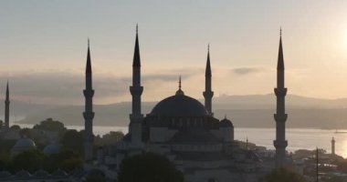 Istanbul, Turkey. Sultanahmet area with the Blue Mosque and the Hagia Sophia with a Golden Horn and Bosphorus bridge in the background at sunrise. Cinematic Aerial view. Hi quality 4K footage.
