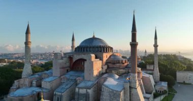 Istanbul, Turkey. Sultanahmet with the Blue Mosque and the Hagia Sophia with a Golden Horn on the background at sunrise. Cinematic Aerial view. Hi quality 4K footage.