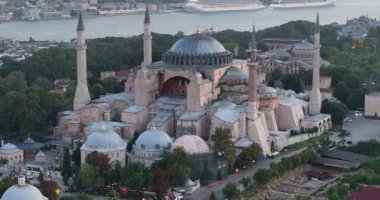 Istanbul, Turkey. Sultanahmet with the Blue Mosque and the Hagia Sophia with a Golden Horn on the background at sunrise. Cinematic Aerial view. Hi quality 4K footage.