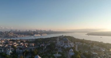 Istanbul, Turkey. Sultanahmet with the Blue Mosque and the Hagia Sophia with a Golden Horn on the background at sunrise. Cinematic Aerial view. Hi quality 4K footage.