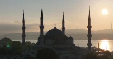 Istanbul, Turkey. Sultanahmet area with the Blue Mosque and the Hagia Sophia with a Golden Horn and Bosphorus bridge in the background at sunrise. Cinematic Aerial view. Hi quality 4K footage.