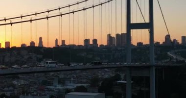 Istanbul Bosphorus Bridge and City Skyline in Background with Turkish Flag at Beautiful Sunset, Aerial slide orbiting and tracking shot. High quality cinematic 4k footage