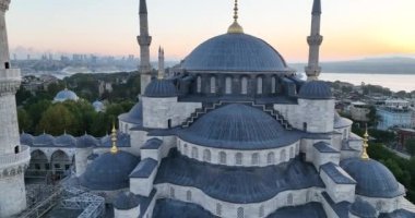 Istanbul, Turkey. Sultanahmet area with the Blue Mosque and the Hagia Sophia with a Golden Horn and Bosphorus bridge in the background at sunrise. Cinematic Aerial view. Hi quality 4K footage.