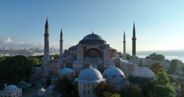 Istanbul, Turkey. Sultanahmet area with the Blue Mosque and the Hagia Sophia with a Golden Horn and Bosphorus bridge in the background at sunrise. Cinematic Aerial view. Hi quality 4K footage.