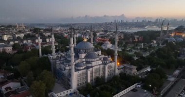Istanbul, Turkey. Sultanahmet with the Blue Mosque and the Hagia Sophia with a Golden Horn on the background at sunrise. Cinematic Aerial view. Hi quality 4K footage.
