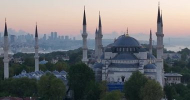 Istanbul, Turkey. Sultanahmet area with the Blue Mosque and the Hagia Sophia with a Golden Horn and Bosphorus bridge in the background at sunrise. Cinematic Aerial view. Hi quality 4K footage.