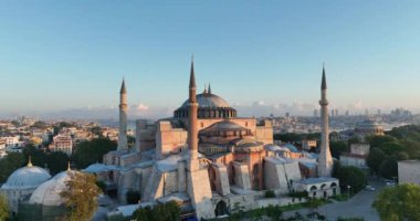 Istanbul, Turkey. Sultanahmet with the Blue Mosque and the Hagia Sophia with a Golden Horn on the background at sunrise. Cinematic Aerial view. Hi quality 4K footage.
