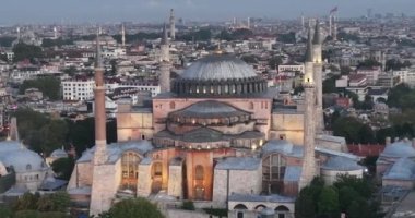 Istanbul, Turkey. Sultanahmet with the Blue Mosque and the Hagia Sophia with a Golden Horn on the background at sunrise. Cinematic Aerial view. Hi quality 4K footage.