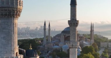 Istanbul, Turkey. Sultanahmet area with the Blue Mosque and the Hagia Sophia with a Golden Horn and Bosphorus bridge in the background at sunrise. Cinematic Aerial view. Hi quality 4K footage.