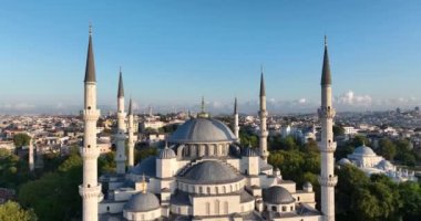 Istanbul, Turkey. Sultanahmet with the Blue Mosque and the Hagia Sophia with a Golden Horn on the background at sunrise. Cinematic Aerial view. Hi quality 4K footage.