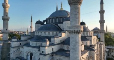 Istanbul, Turkey. Sultanahmet with the Blue Mosque and the Hagia Sophia with a Golden Horn on the background at sunrise. Cinematic Aerial view. Hi quality 4K footage.