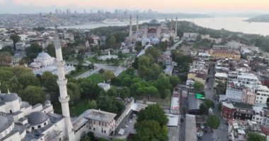 Istanbul, Turkey. Sultanahmet area with the Blue Mosque and the Hagia Sophia with a Golden Horn and Bosphorus bridge in the background at sunrise. Cinematic Aerial view. Hi quality 4K footage.