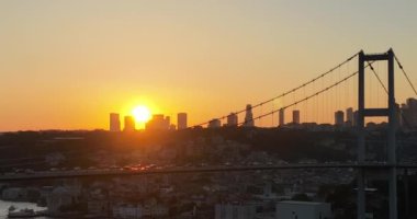 Istanbul Bosphorus Bridge and City Skyline in Background with Turkish Flag at Beautiful Sunset, Aerial slide orbiting and tracking shot. High quality cinematic 4k footage