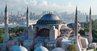 Istanbul, Turkey. Sultanahmet with the Blue Mosque and the Hagia Sophia with a Golden Horn on the background at sunrise. Cinematic Aerial view. Hi quality 4K footage.
