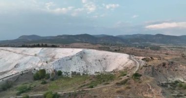 Pamukkale Travertines Cinematic Aerial Drone footage. Turkish famous white thermal bath with healthy clean water in a beautiful sunset. Aegean Region, Denizli Turkey