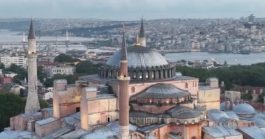 Istanbul, Turkey. Sultanahmet with the Blue Mosque and the Hagia Sophia with a Golden Horn on the background at sunrise. Cinematic Aerial view. Hi quality 4K footage.