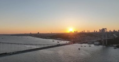 Istanbul Bosphorus Bridge and City Skyline in Background with Turkish Flag at Beautiful Sunset, Aerial slide orbiting and tracking shot. High quality cinematic 4k footage