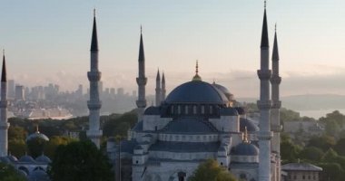 Istanbul, Turkey. Sultanahmet with the Blue Mosque and the Hagia Sophia with a Golden Horn on the background at sunrise. Cinematic Aerial view. Hi quality 4K footage.
