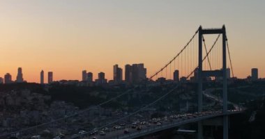 Istanbul Bosphorus Bridge and City Skyline in Background with Turkish Flag at Beautiful Sunset, Aerial slide orbiting and tracking shot. High quality cinematic 4k footage