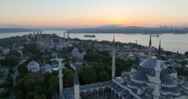 Istanbul, Turkey. Sultanahmet area with the Blue Mosque and the Hagia Sophia with a Golden Horn and Bosphorus bridge in the background at sunrise. Cinematic Aerial view. Hi quality 4K footage.