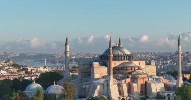 Istanbul, Turkey. Sultanahmet with the Blue Mosque and the Hagia Sophia with a Golden Horn on the background at sunrise. Cinematic Aerial view. Hi quality 4K footage.