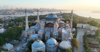 Istanbul, Turkey. Sultanahmet with the Blue Mosque and the Hagia Sophia with a Golden Horn on the background at sunrise. Cinematic Aerial view. Hi quality 4K footage.