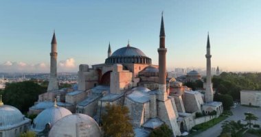 Istanbul, Turkey. Sultanahmet with the Blue Mosque and the Hagia Sophia with a Golden Horn on the background at sunrise. Cinematic Aerial view. Hi quality 4K footage.