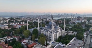 Istanbul, Turkey. Sultanahmet area with the Blue Mosque and the Hagia Sophia with a Golden Horn and Bosphorus bridge in the background at sunrise. Cinematic Aerial view. Hi quality 4K footage.