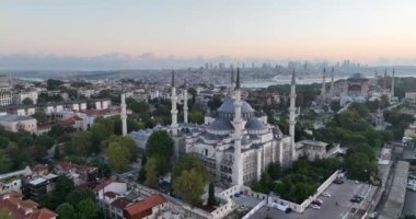 Istanbul, Turkey. Sultanahmet with the Blue Mosque and the Hagia Sophia with a Golden Horn on the background at sunrise. Cinematic Aerial view. Hi quality 4K footage.