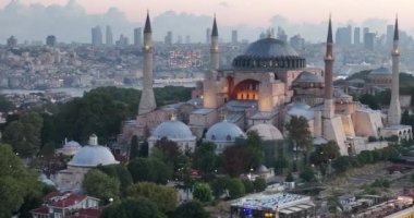 Istanbul, Turkey. Sultanahmet with the Blue Mosque and the Hagia Sophia with a Golden Horn on the background at sunrise. Cinematic Aerial view. Hi quality 4K footage.