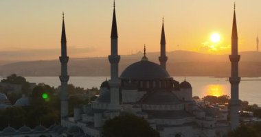 Istanbul, Turkey. Sultanahmet with the Blue Mosque and the Hagia Sophia with a Golden Horn on the background at sunrise. Cinematic Aerial view. Hi quality 4K footage.