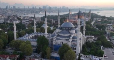 Istanbul, Turkey. Sultanahmet area with the Blue Mosque and the Hagia Sophia with a Golden Horn and Bosphorus bridge in the background at sunrise. Cinematic Aerial view. Hi quality 4K footage.