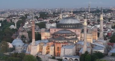 Istanbul, Turkey. Sultanahmet area with the Blue Mosque and the Hagia Sophia with a Golden Horn and Bosphorus bridge in the background at sunrise. Cinematic Aerial view. Hi quality 4K footage.