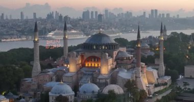 Istanbul, Turkey. Sultanahmet with the Blue Mosque and the Hagia Sophia with a Golden Horn on the background at sunrise. Cinematic Aerial view. Hi quality 4K footage.