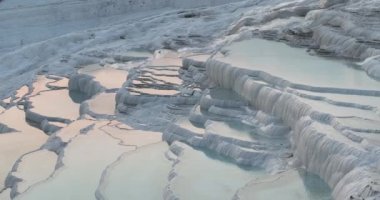 Pamukkale Travertines Cinematic Aerial Drone footage. Turkish famous white thermal bath with healthy clean water in a beautiful sunset. Aegean Region, Denizli Turkey