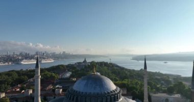 Istanbul, Turkey. Sultanahmet with the Blue Mosque and the Hagia Sophia with a Golden Horn on the background at sunrise. Cinematic Aerial view. Hi quality 4K footage.