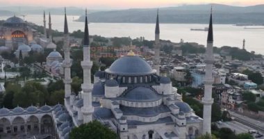 Istanbul, Turkey. Sultanahmet with the Blue Mosque and the Hagia Sophia with a Golden Horn on the background at sunrise. Cinematic Aerial view. Hi quality 4K footage.