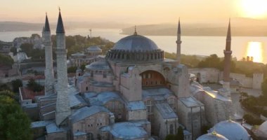 Istanbul, Turkey. Sultanahmet with the Blue Mosque and the Hagia Sophia with a Golden Horn on the background at sunrise. Cinematic Aerial view. Hi quality 4K footage.