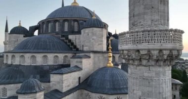 Istanbul, Turkey. Sultanahmet with the Blue Mosque and the Hagia Sophia with a Golden Horn on the background at sunrise. Cinematic Aerial view. Hi quality 4K footage.