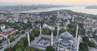 Istanbul, Turkey. Sultanahmet area with the Blue Mosque and the Hagia Sophia with a Golden Horn and Bosphorus bridge in the background at sunrise. Cinematic Aerial view. Hi quality 4K footage.