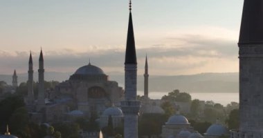 Istanbul, Turkey. Sultanahmet area with the Blue Mosque and the Hagia Sophia with a Golden Horn and Bosphorus bridge in the background at sunrise. Cinematic Aerial view. Hi quality 4K footage.