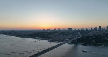 Istanbul Bosphorus Bridge and City Skyline in Background with Turkish Flag at Beautiful Sunset, Aerial slide orbiting and tracking shot. High quality cinematic 4k footage