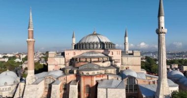 Istanbul, Turkey. Sultanahmet with the Blue Mosque and the Hagia Sophia with a Golden Horn on the background at sunrise. Cinematic Aerial view. Hi quality 4K footage.