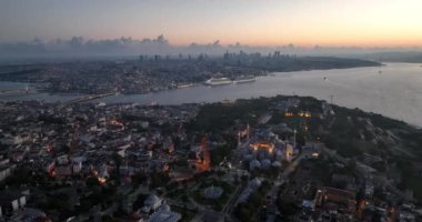 Istanbul, Turkey. Sultanahmet area with the Blue Mosque and the Hagia Sophia with a Golden Horn and Bosphorus bridge in the background at sunrise. Cinematic Aerial view. Hi quality 4K footage.